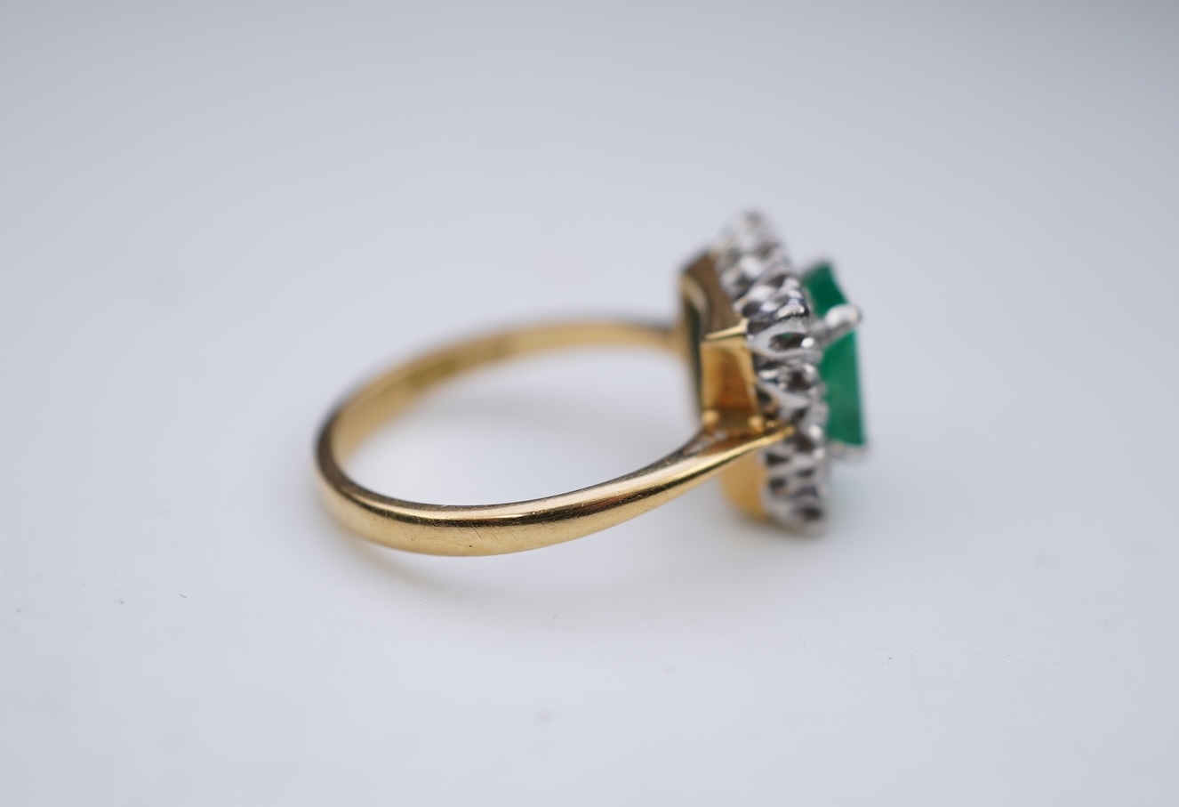 An emerald and diamond ring